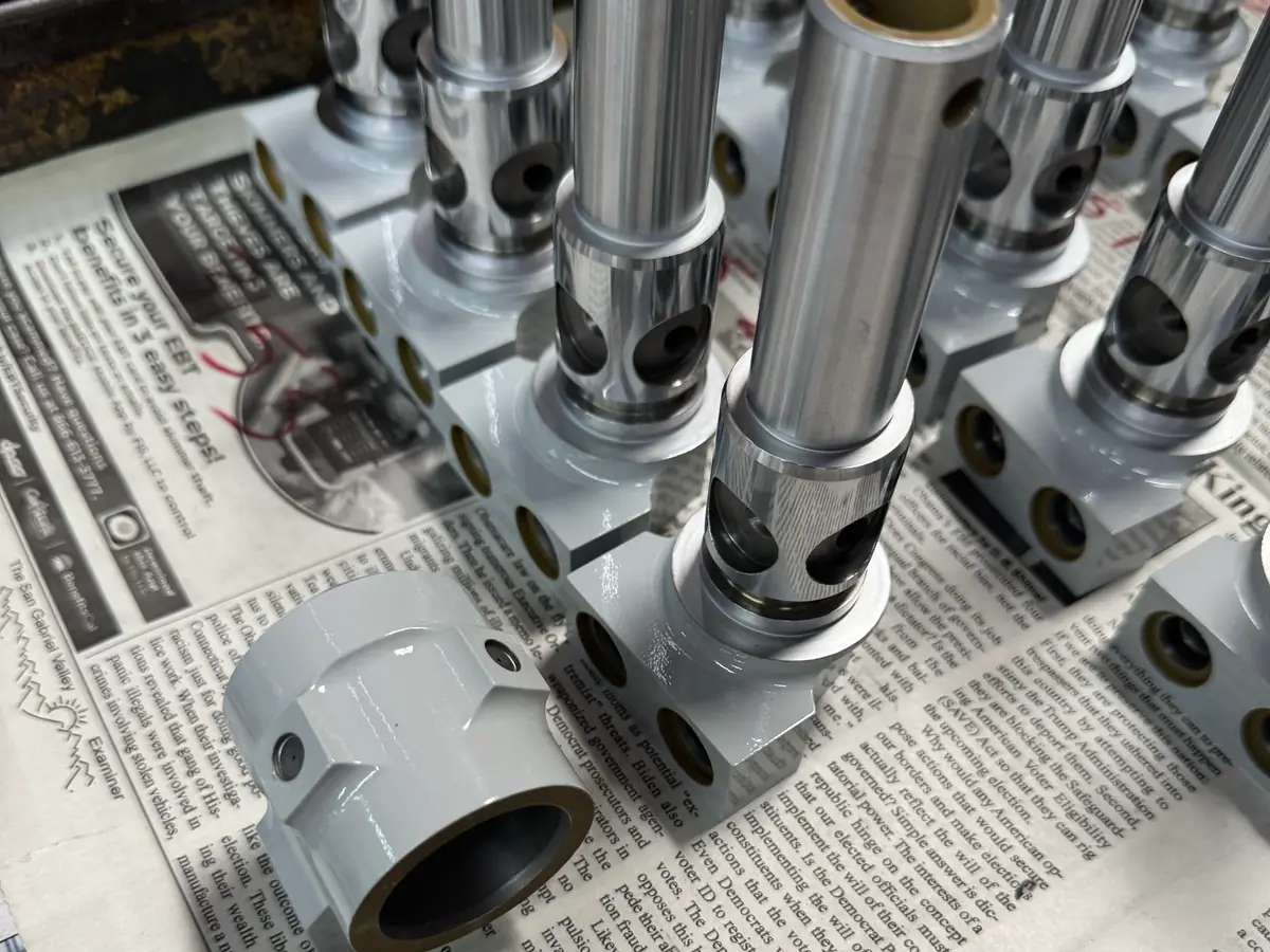 Actuator cylinder assemblies with ground rods and bronze bushings